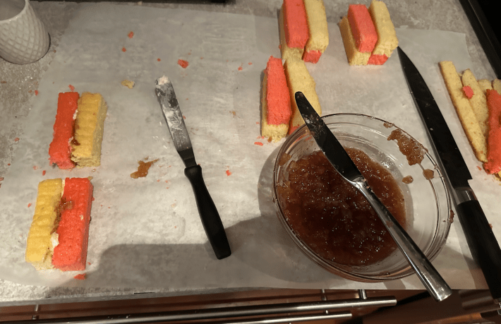 assembly line of cakes and jam and buttercream